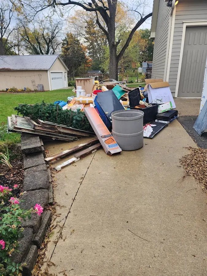 Dumpster being loaded with debris for Residential Dumpster Rental in Dedham